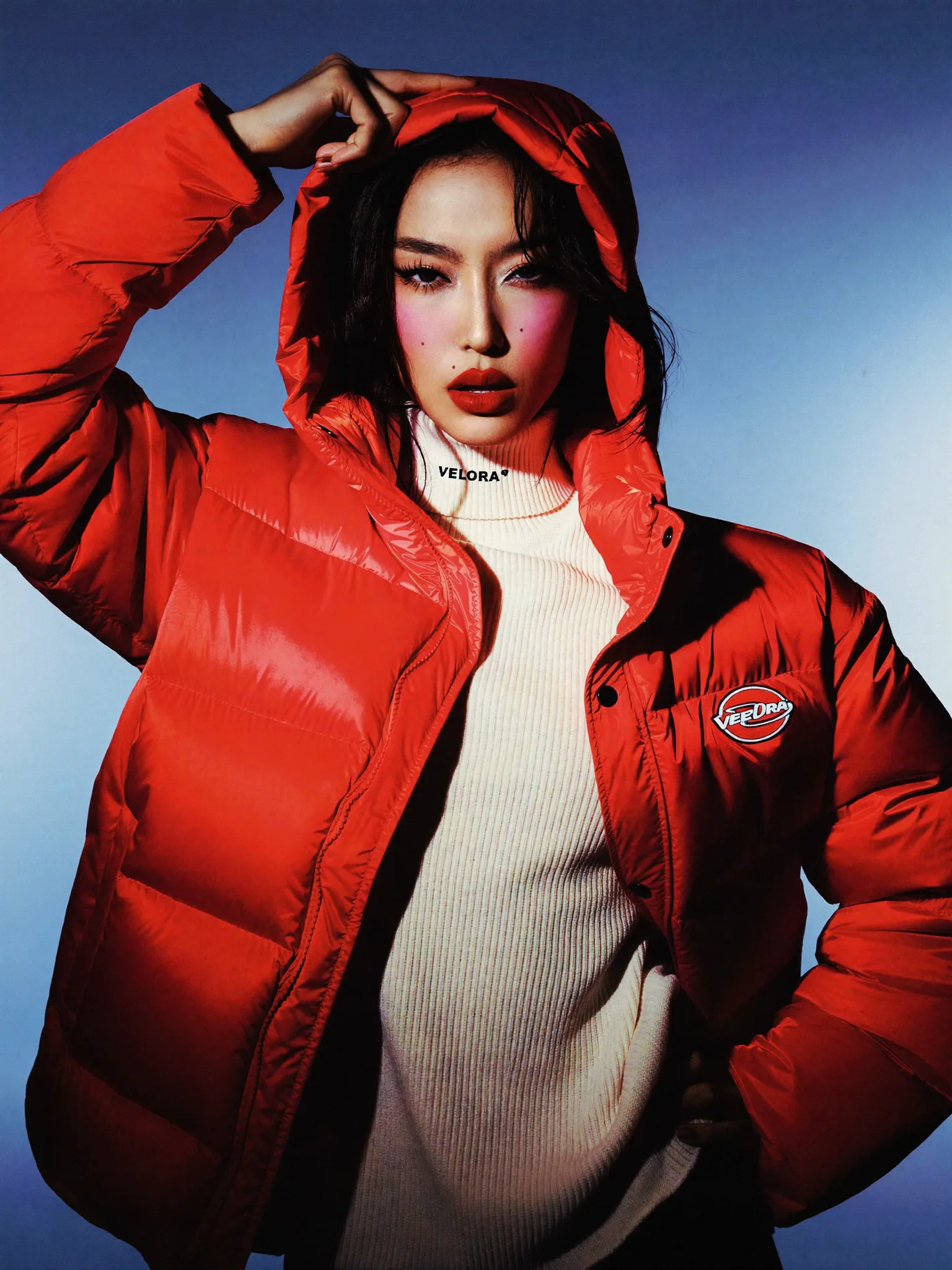 Red outerwear against a clear blue sky